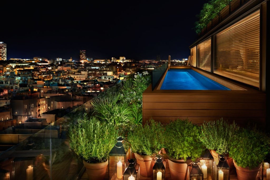 Modern luxury hotel facade at dusk with illuminated windows, sleek glass and stone architecture, central Barcelona location