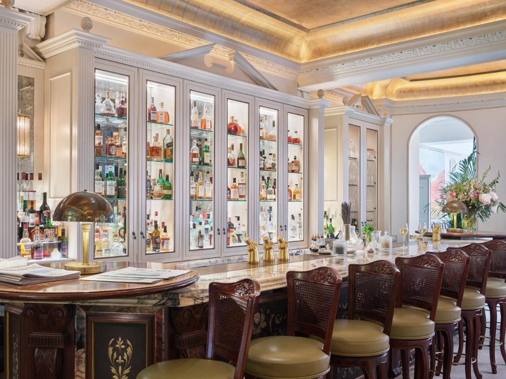 Elegant five-star hotel with white Victorian facade, featuring ornate windows, wrought-iron balconies and manicured landscaping in London