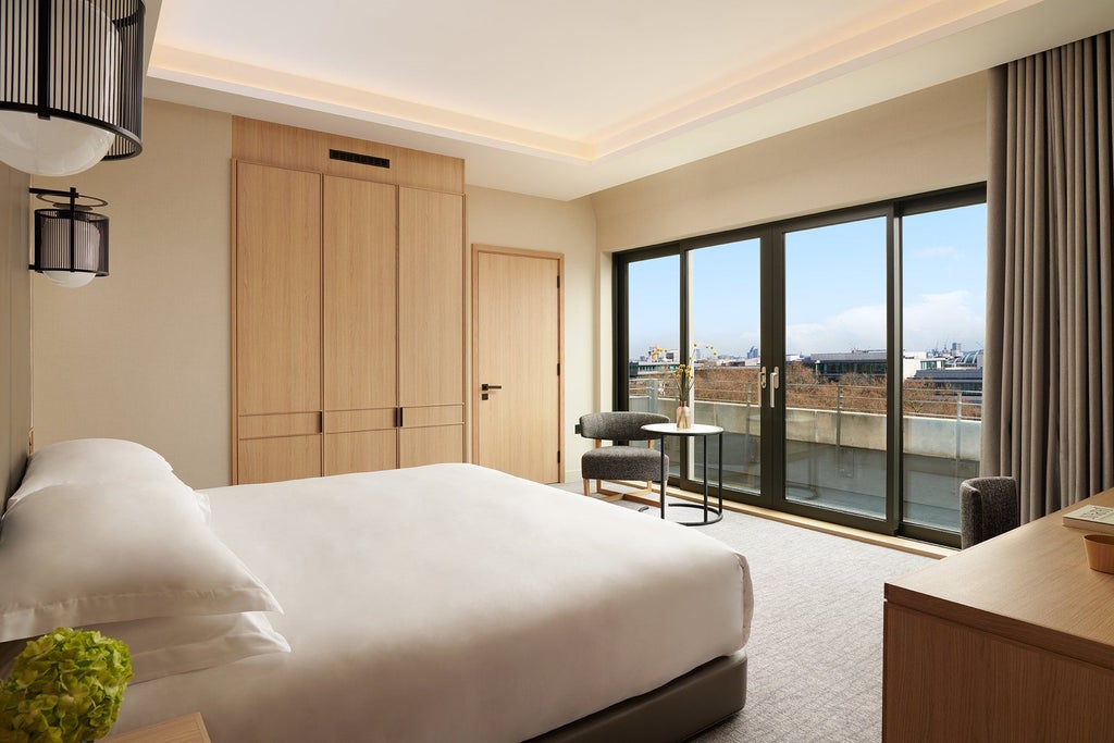 Spacious luxurious penthouse suite with contemporary Japanese-inspired design, elegant neutral tones, floor-to-ceiling windows overlooking cityscape at scenset Hotel London Portman Square