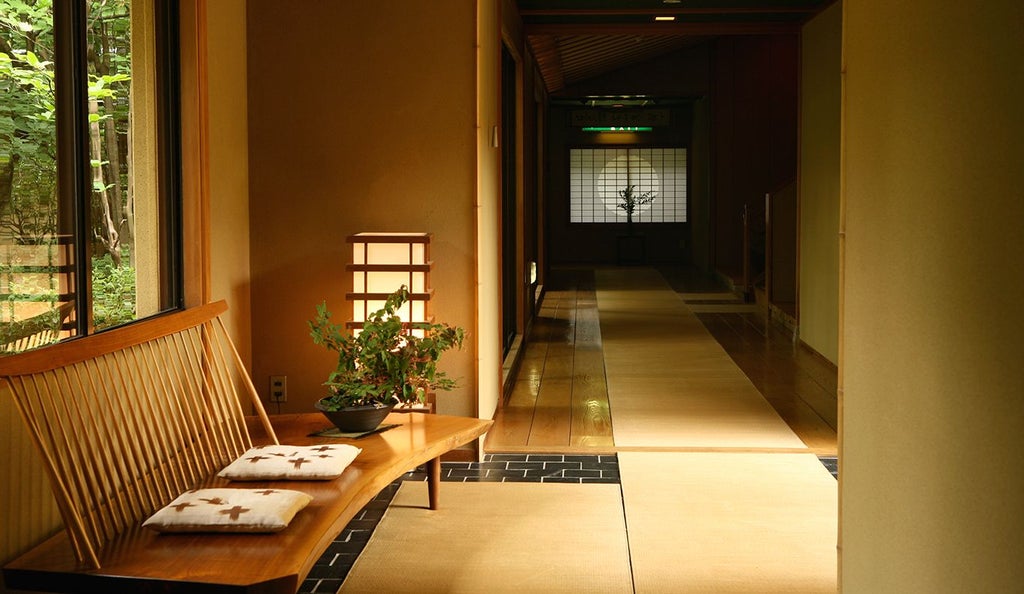 Serene Japanese ryokan nestled in lush mountain landscape, traditional wooden architecture with elegant minimalist design and zen garden view.