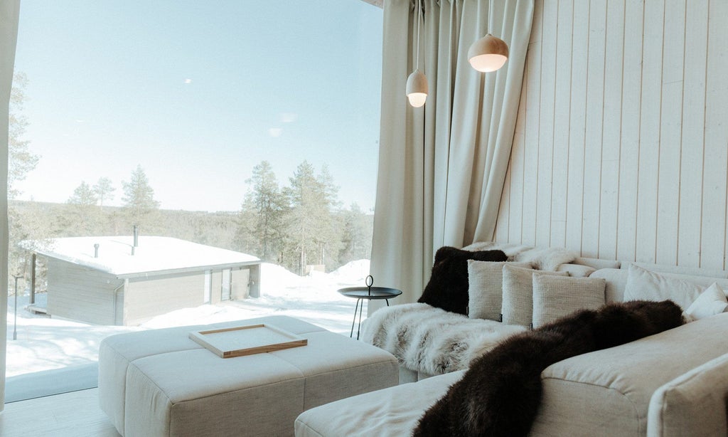 Panoramic Arctic Suite with expansive floor-to-ceiling windows overlooking snow-covered pine forest, minimalist Nordic design, warm wood tones, and cozy contemporary furnishings