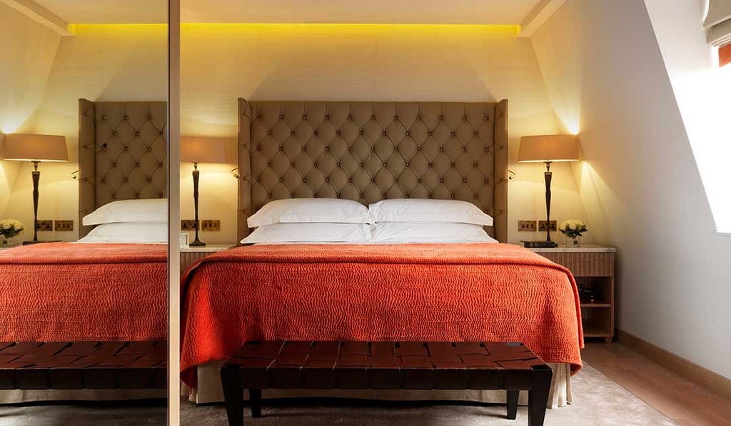 Elegant Marylebone Suite with plush king bed, contemporary designer furnishings, and soft neutral color palette showcasing urban luxury hotel accommodation in scenset