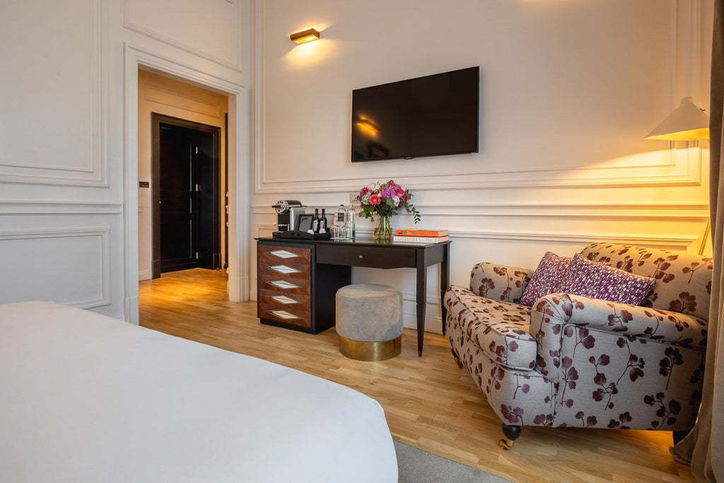 Luxurious double deluxe hotel room at Palazzo Dama, featuring elegant white decor, plush bed, contemporary Italian design, and sophisticated minimalist styling.