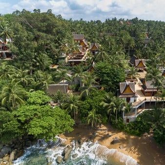 Luxurious Thai pavilions nestled among palm trees overlooking turquoise Andaman Sea, featuring private infinity pools and teak terraces