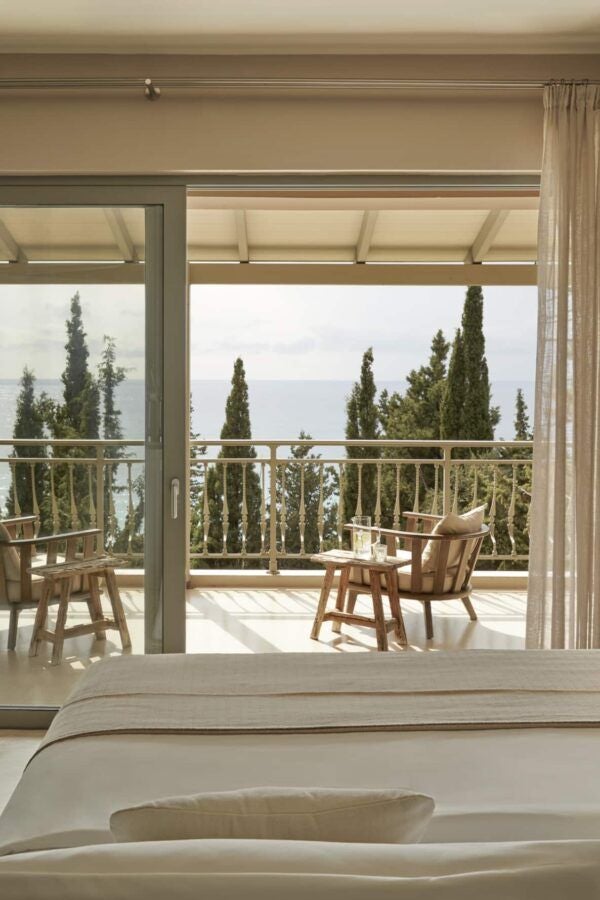 Minimalist luxury retreat with white marble floor, king-sized bed, and panoramic sea view from private balcony at F Zeen Kefalonia, Greece