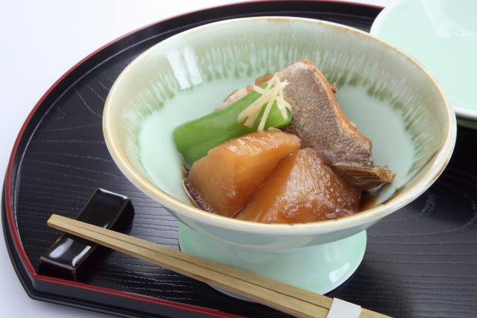 An example of a obanzai lunch of simmered yellowtail, daikon radish and sweet pepper
