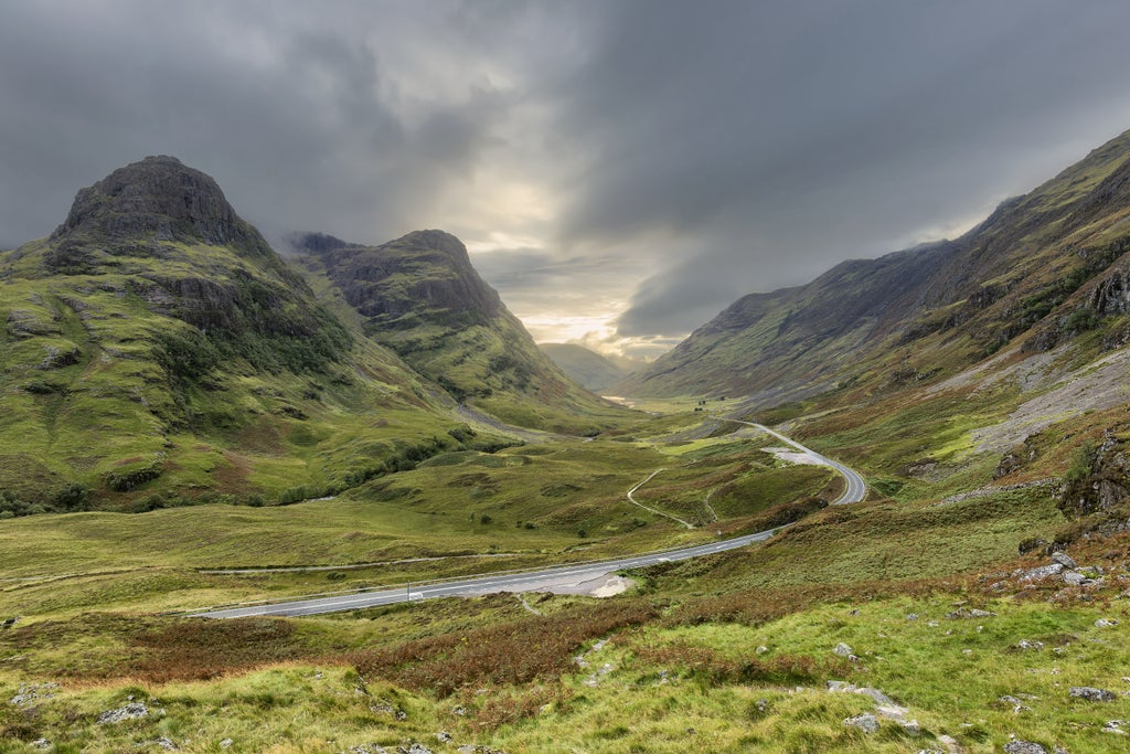 Scenic gondola ascending Ben Nevis mountain in Scottish Highlands, revealing dramatic Glencoe landscape with rugged peaks and lush green valleys at sunset