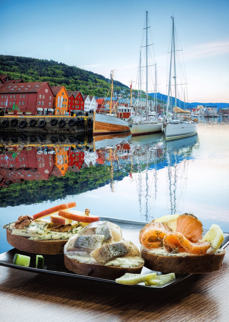 Vibrant seafood market scene in Bergen, Norway, with elegant fishmongers displaying fresh catch, colorful wooden buildings in background