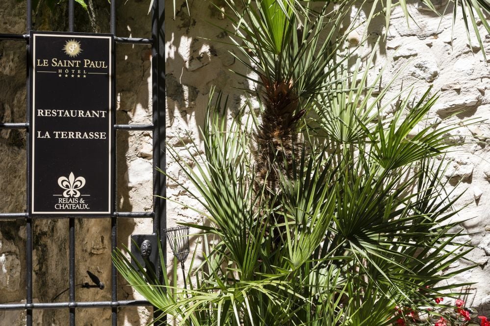 Elegant stone facade of Hotel in scenic French countryside, featuring classic architectural details and charming cobblestone street entrance