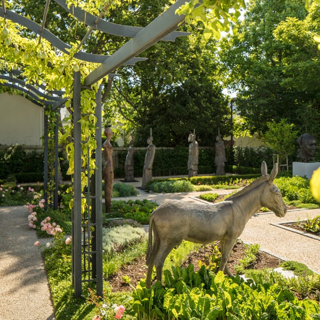 Elegant boutique hotel with white Cape Dutch colonial architecture, manicured gardens, and luxury pool terrace in Franschhoek Valley