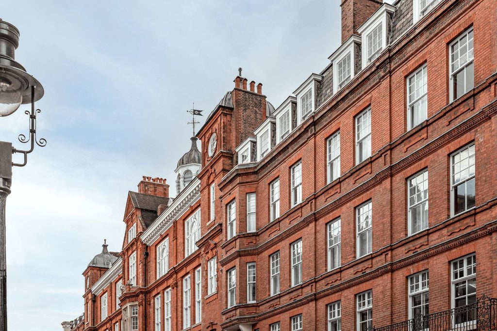 Elegant boutique hotel facade with white-and-blue exterior, vintage Victorian architecture, nestled in a charming urban streetscape in central United Kingdom