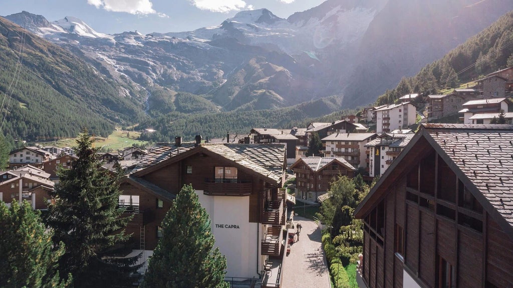 Luxurious alpine hotel nestled in scenic Swiss mountains, featuring modern chalet-style architecture with expansive windows and minimalist wooden design elements