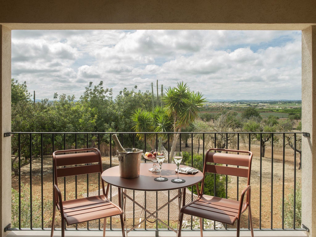 Elegant Lodge Terrace Suite with panoramic Mediterranean views, luxurious modern furnishings, and a spacious private balcony overlooking scenic Spanish landscape