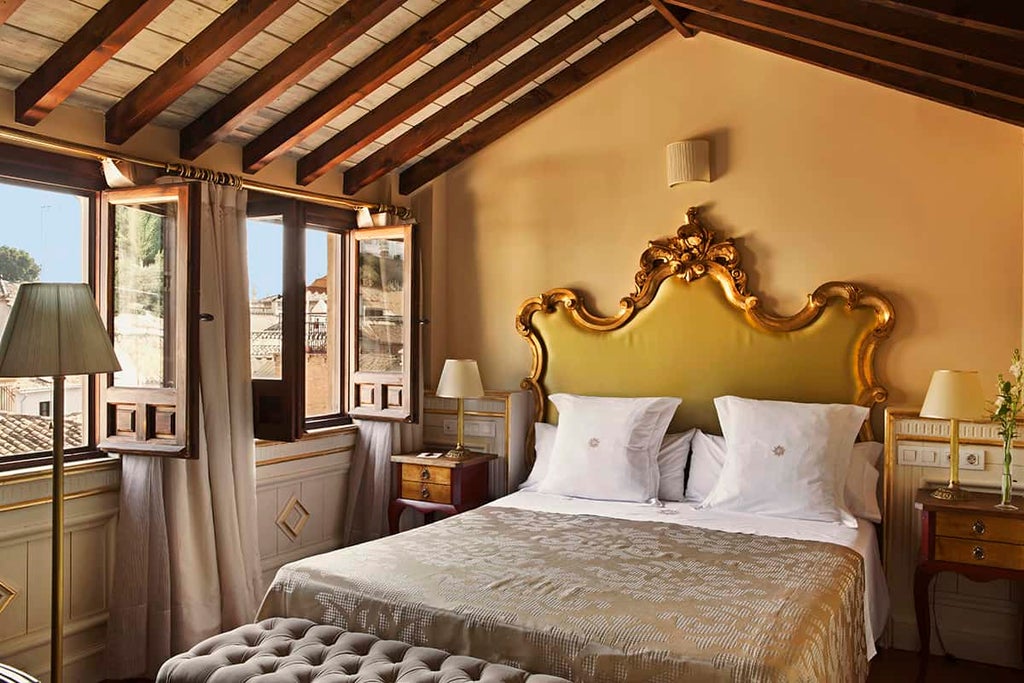 Elegant boutique hotel in Granada featuring ornate Moorish-style archways, crystal chandeliers, and a grand marble courtyard