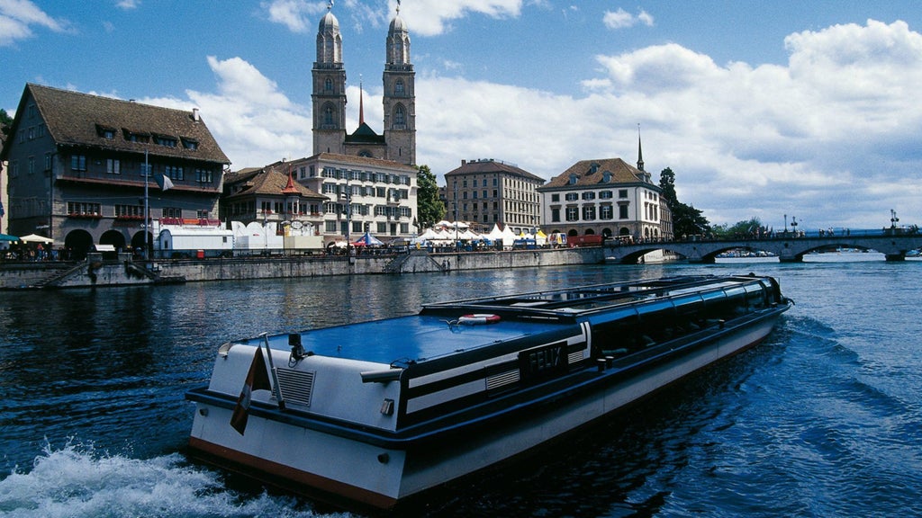 Elegant lakeside hotel with Swiss Alps backdrop, pristine waters of Lake Zurich, modern architectural design blending luxury and natural beauty