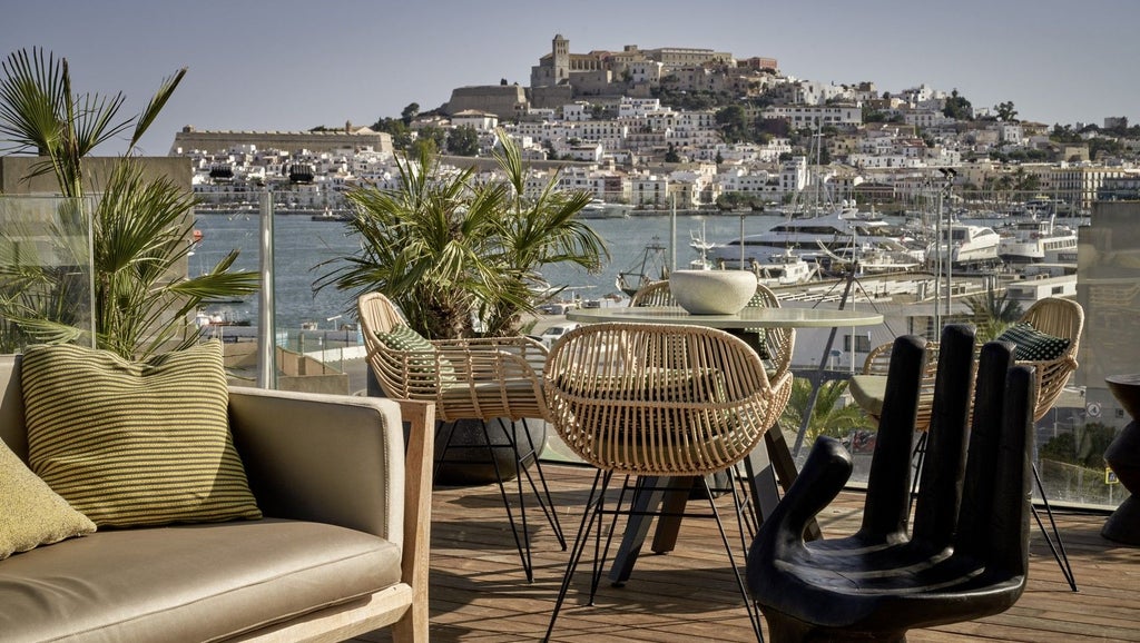 Sleek white modern hotel facade with minimalist design, nestled in urban landscape of Ibiza, featuring chic architectural lines and luxurious Mediterranean styling