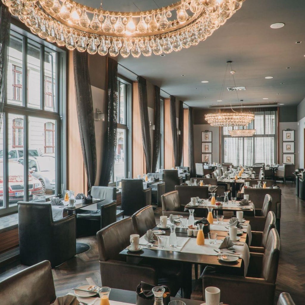 Luxurious Art Deco hotel lobby with crystal chandeliers, plush velvet seating, and elegant marble floors in Prague's historic city center