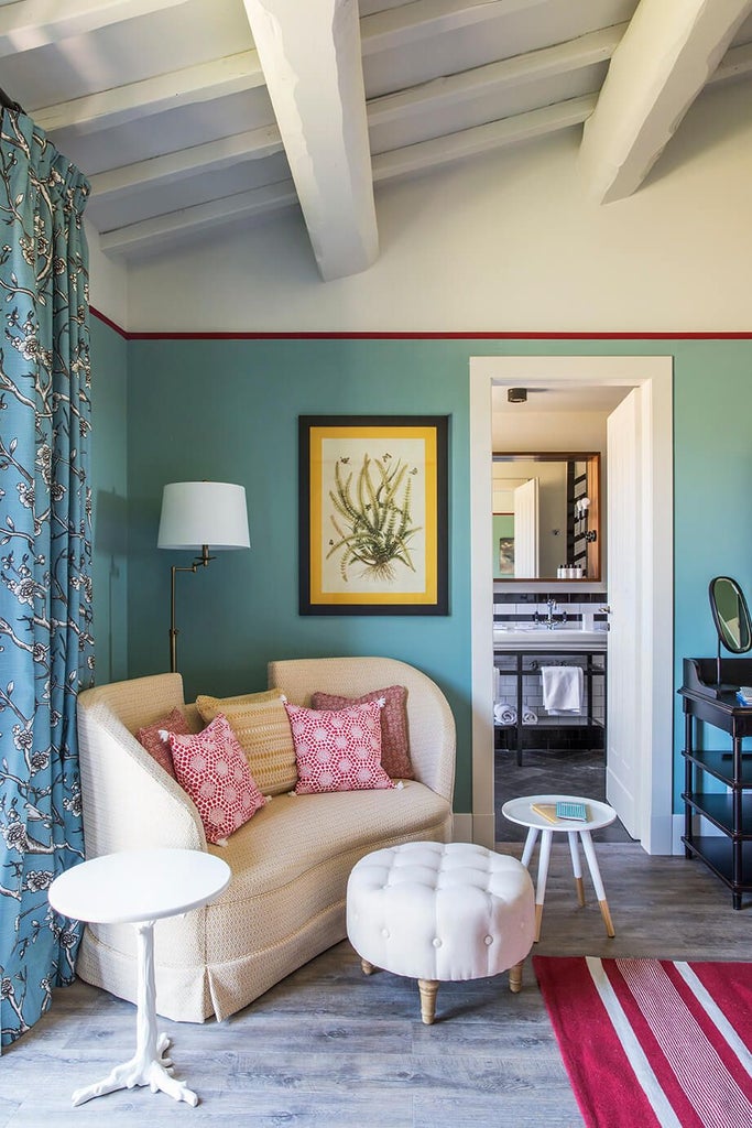 Elegant Deluxe Junior Suite King at Locanda Rossa, featuring plush bedding, rustic Italian decor, and warm neutral tones with soft natural lighting