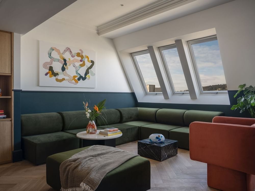 Spacious presidential suite with elegant Czech design, plush king bed, modern marble bathroom, city skyline view in luxurious Almanac hotel in Prague