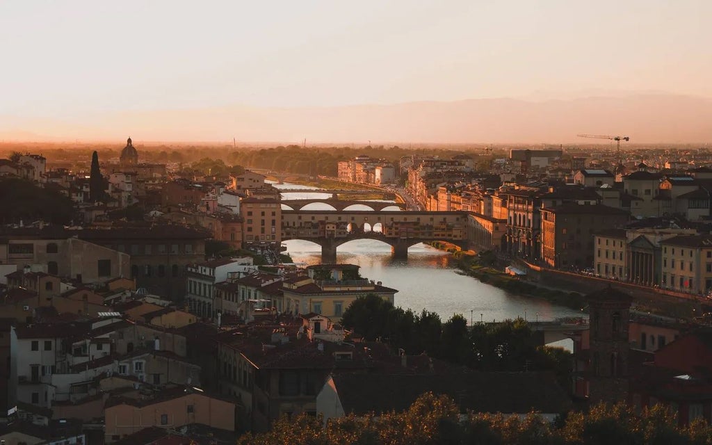 Modern luxurious boutique hotel with sleek white exterior, large windows, and elegant contemporary architecture in central Florence, Italy