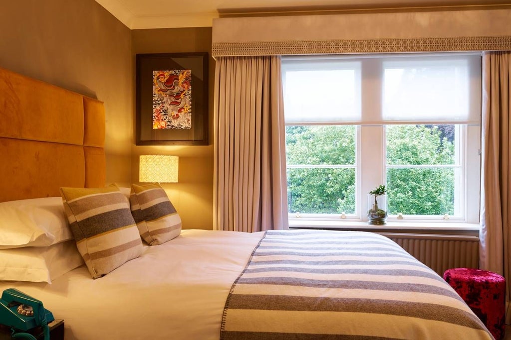 Elegant cozy double hotel room with plush bedding, warm wooden accents, soft lighting, and urban-chic design featuring neutral tones and contemporary furnishings