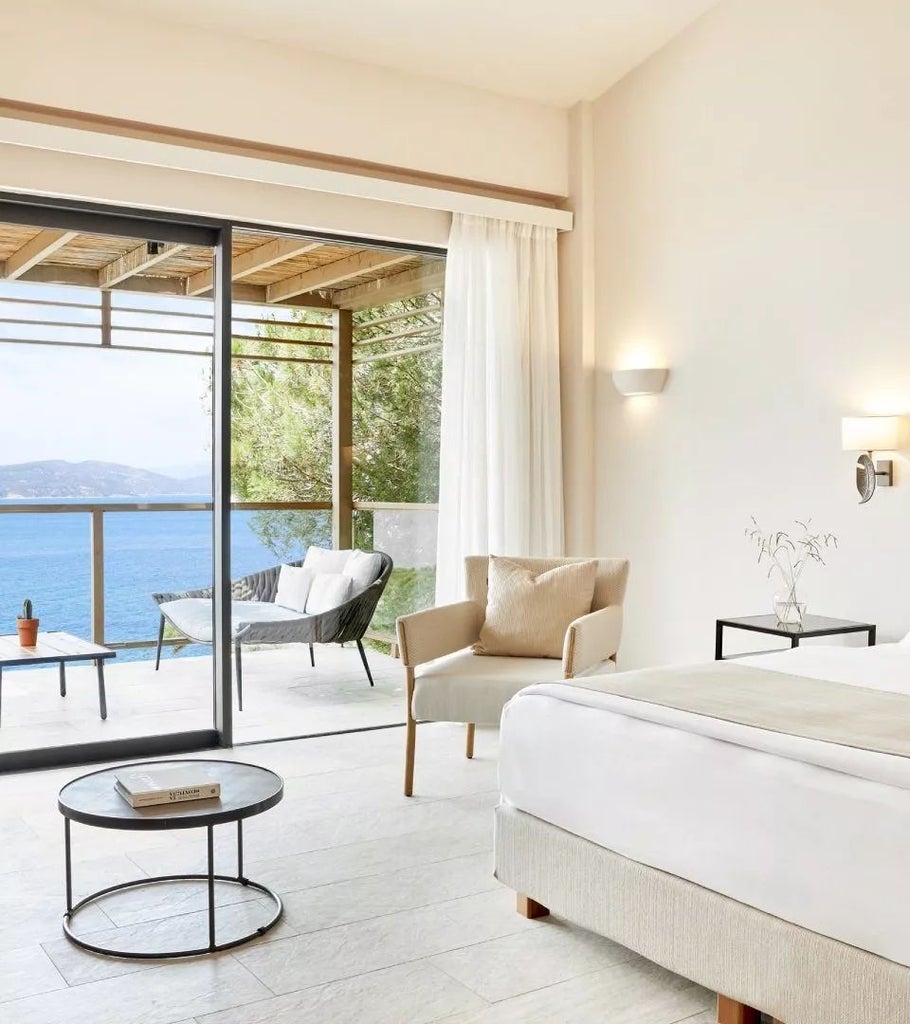 Luxurious interconnected suite at ELIVI Skiathos hotel, featuring a private hot tub, elegant design, and breathtaking views of the Greek island landscape