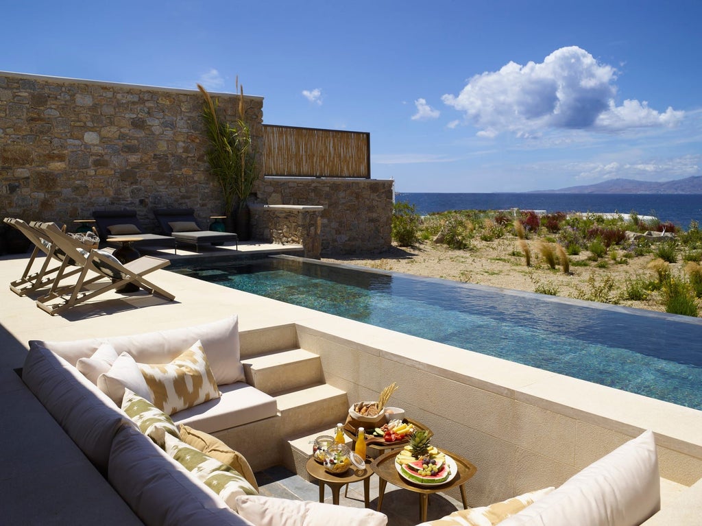 Luxurious one-bedroom villa in Mykonos with panoramic sea view, private heated pool, and elegant white-washed Mediterranean architectural design