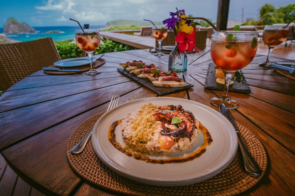 Luxurious beachfront pousada with panoramic ocean view, nestled on scenic Brazilian coastline, featuring modern architecture and tropical landscape.