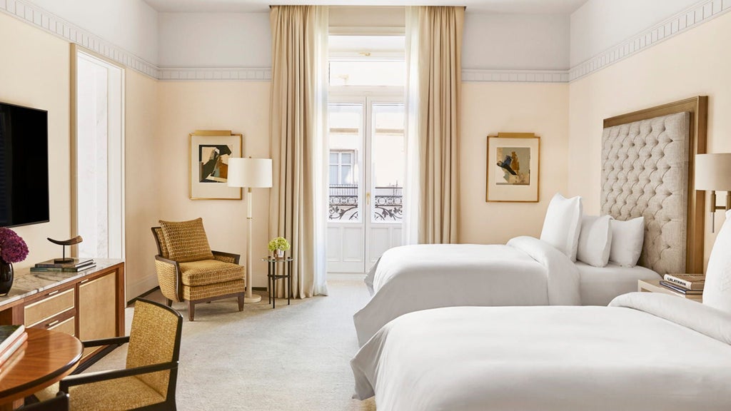 Elegant Premier Room with plush king bed, marble bath, floor-to-ceiling windows and city views at Four Seasons Madrid Hotel