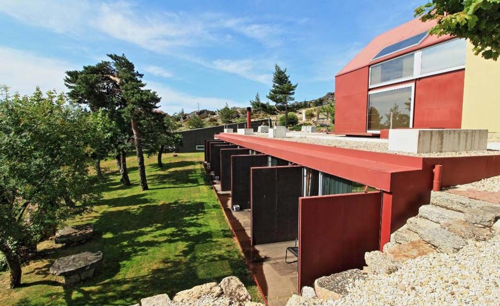 Luxurious mountain retreat with modern design, featuring white architectural lines against rugged Serra da Estrela landscape, blending contemporary comfort with natural beauty