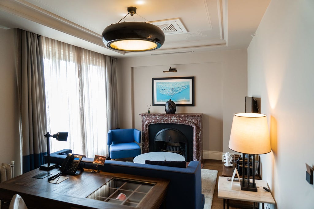 Luxurious executive suite with elegant marble bathroom, plush king bed, city view windows, and sophisticated Turkish-inspired modern decor in Istanbul hotel