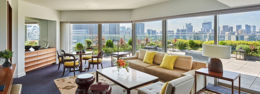 Spacious terrace suite at Palace Hotel Tokyo overlooking city skyline, featuring modern minimalist decor, floor-to-ceiling windows, and elegant Japanese design elements