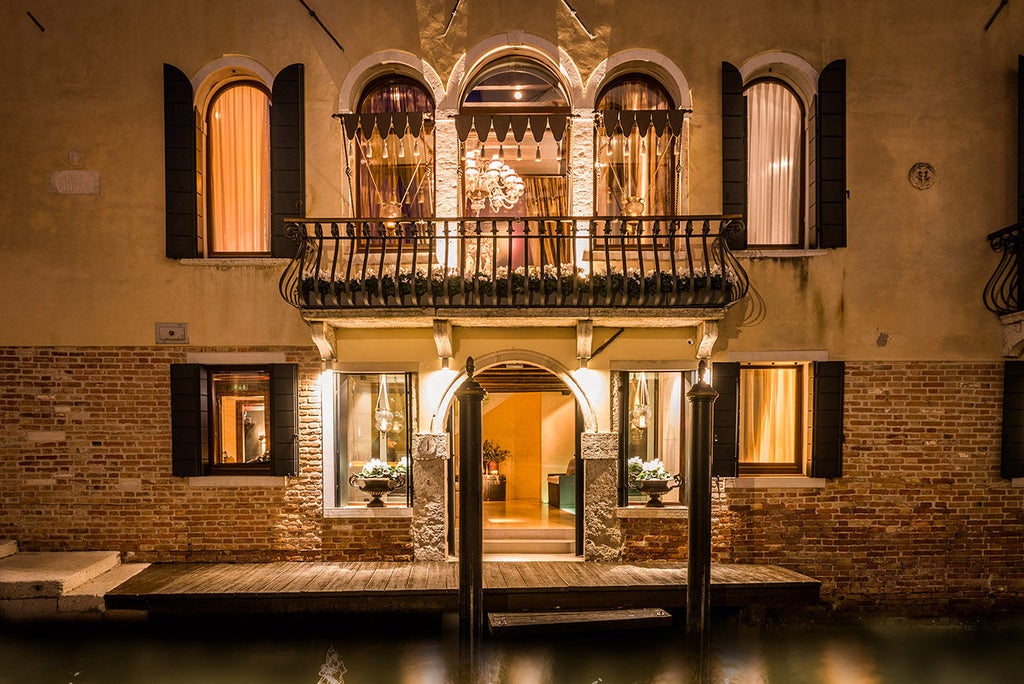 Elegant boutique hotel in Venice featuring ornate Venetian decor, overlooking Santa Maria della Salute Basilica dome