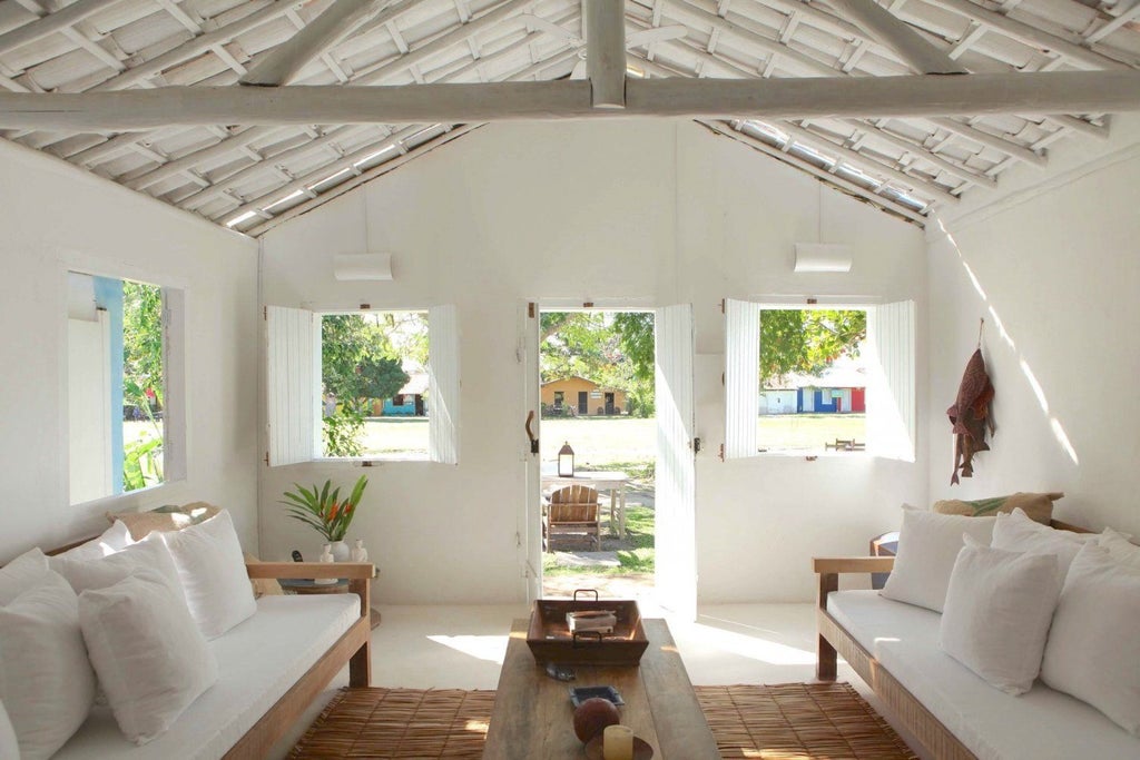 Rustic wooden bed with handcrafted details in a luxurious Brazilian boutique hotel room with warm lighting and traditional Bahian design elements