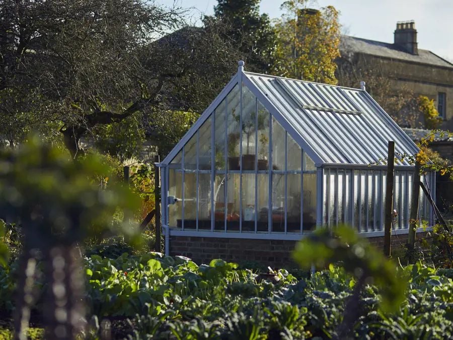 Rustic luxury hotel nestled in scenic South Downs, featuring stone exterior, lush gardens, and elegant countryside charm with warm, inviting architectural details.