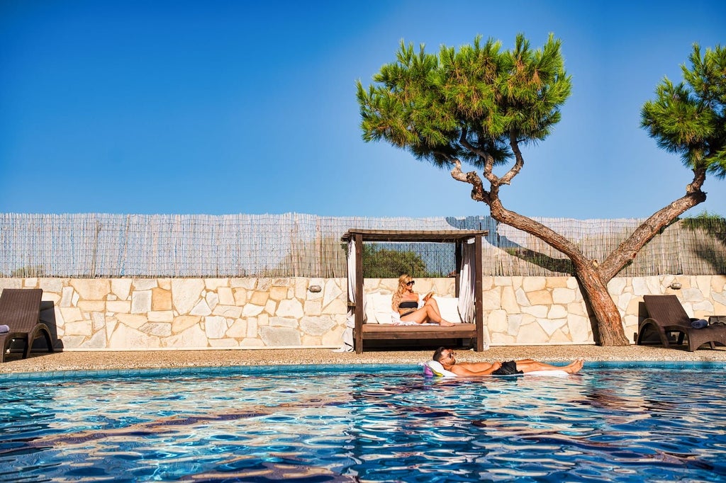 Luxurious white villa with blue-domed roof overlooking azure Aegean Sea, nestled on a cliff with vibrant bougainvillea and pristine infinity pool