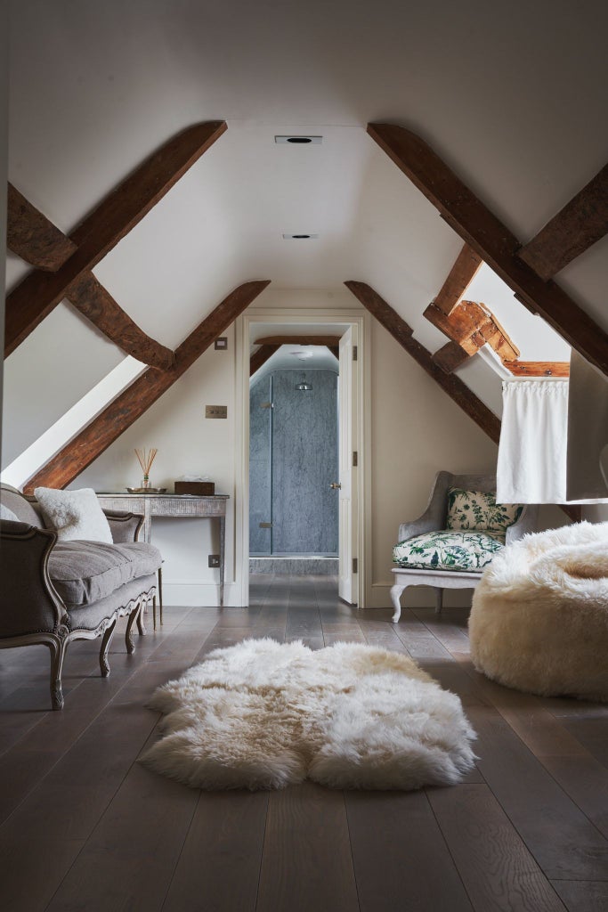 Luxurious UK hotel bedroom with plush king-sized bed, soft neutral tones, elegant thyme-green accents, and refined contemporary design highlighting comfort and style