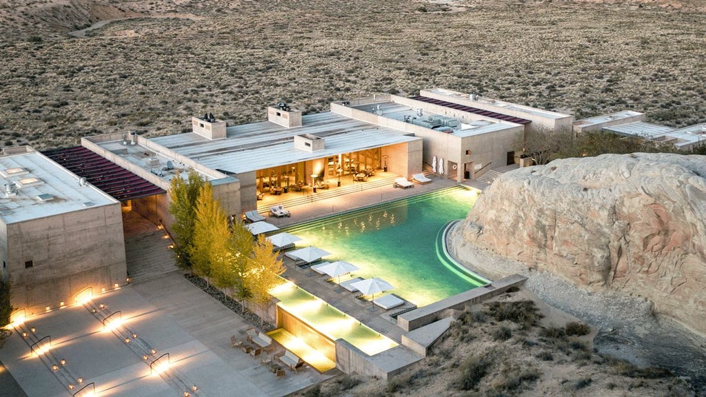 Contemporary luxury desert resort nestled in Canyon Point, Utah with minimalist concrete architecture blending into sandstone landscape