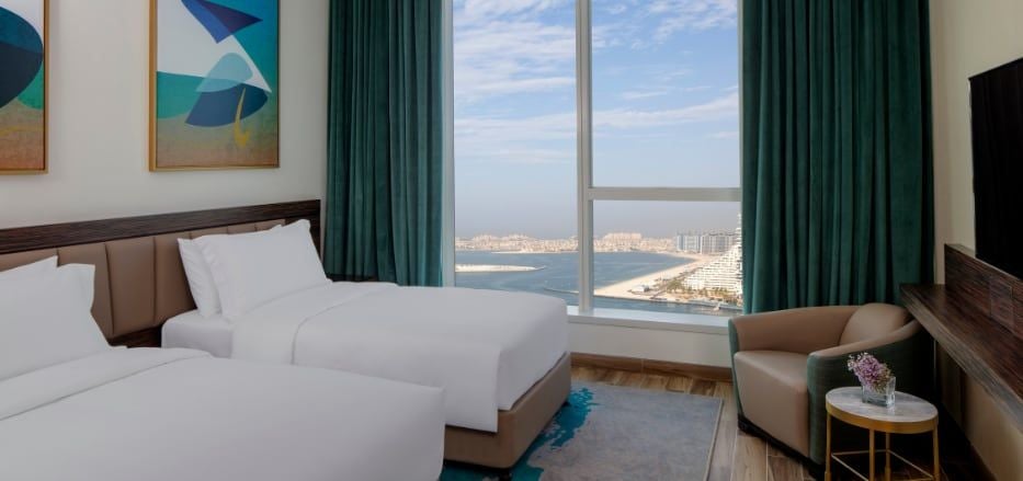 Spacious three-bedroom sea view apartment with modern furnishings, panoramic city skyline, and elegant contemporary design at Scenset hotel in Dubai