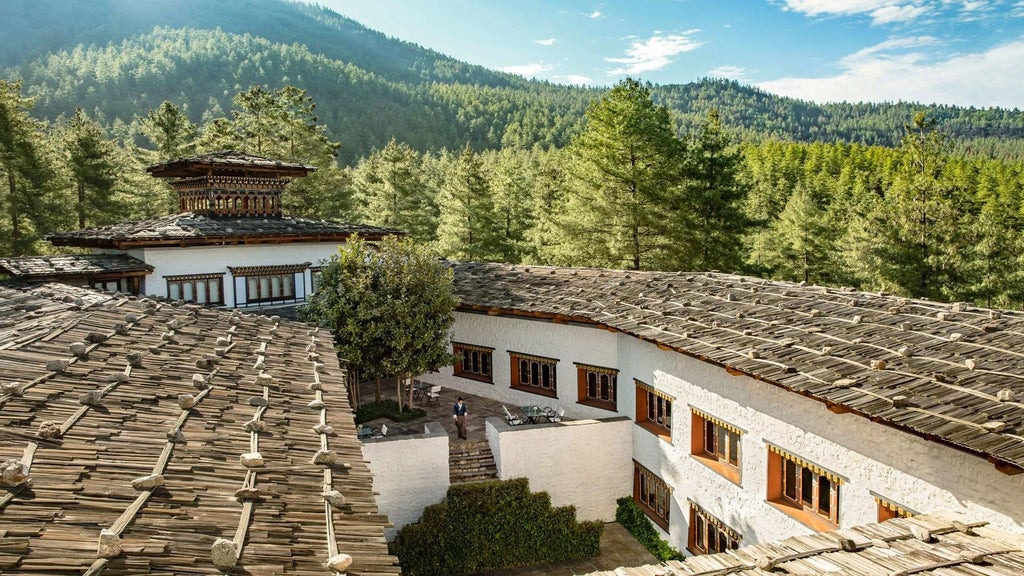 Luxurious COMO Uma Paro hotel nestled in Bhutan's mountainous landscape, with traditional Bhutanese architecture and elegant rustic design elements