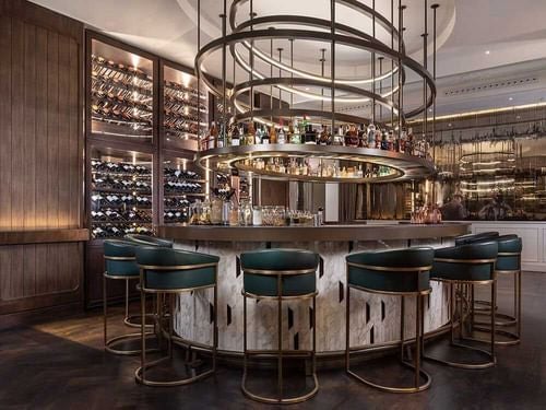 Elegant historic Gran Hotel Inglés lobby with marble columns, crystal chandeliers, and plush seating in Madrid's luxurious city center