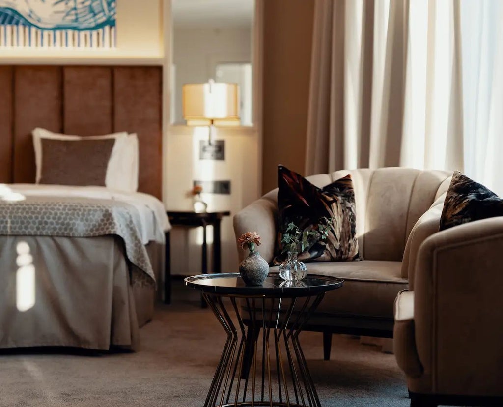 Elegant Swedish hotel room with plush white bedding, soft neutral tones, wooden floors, minimalist design, and large windows with natural light