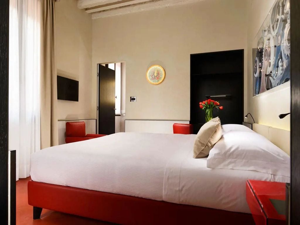 Elegant hotel lobby with vintage clock theme, featuring dark wood paneling, plush red seating, and ornate timepieces on the walls