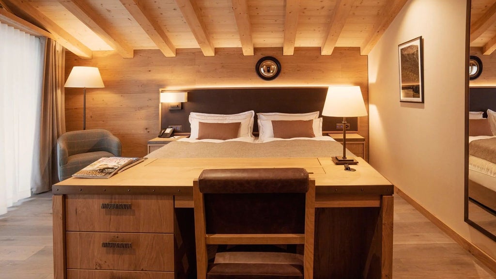 Luxurious Swiss alpine penthouse suite with panoramic mountain views, modern alpine decor, expansive windows, and elegant wood-paneled interiors at scenset hotel