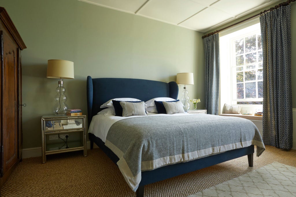 Elegant medium-sized hotel room at The Rectory, featuring crisp white linens, contemporary furnishings, and soft neutral tones with warm wooden accents.