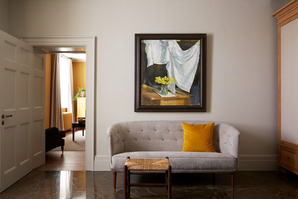 Luxurious earth-toned hotel room at Scenset Place, featuring soft natural light, elegant minimalist decor, and refined textural details with muted ochre accents