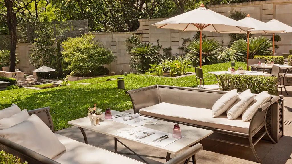 Elegant white Beaux-Arts style palace hotel with ornate facade, manicured garden, and classical architecture in Buenos Aires' Recoleta district