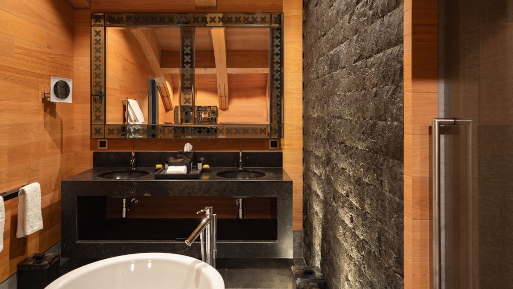 Luxurious Oberalp Suite at The Chedi Andermatt with panoramic alpine views, elegant wooden furnishings, and minimalist Swiss design showcasing mountain landscape