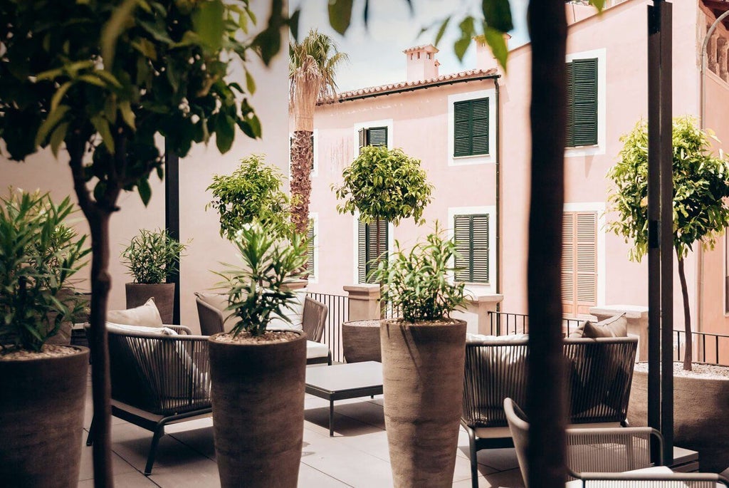 Elegant deluxe hotel room with modern minimalist design, soft neutral tones, wooden floor, and luxurious king-sized bed at Sant Francesc Hotel Singular in Spain