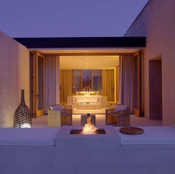 Minimalist desert luxury hotel Amangiri nestled into sandstone cliffs, featuring infinity pool blending with Utah's stark landscape